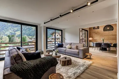 a living room with a couch and a table at La Cordee 221 Penthouse - Chamonix All Year in Chamonix-Mont-Blanc