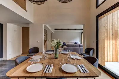 a dining room with a wooden table and chairs at La Cordee 221 Penthouse - Chamonix All Year in Chamonix-Mont-Blanc
