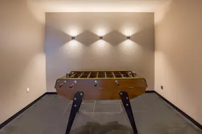 a ping pong table in a room with lights at La Cordee 221 Penthouse - Chamonix All Year in Chamonix-Mont-Blanc