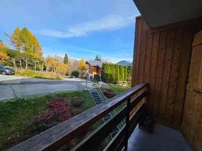 a porch of a house with a fence at Charmant Studio vue montagne - ski, piscine, tennis, randonnées in Saint-Gervais-les-Bains