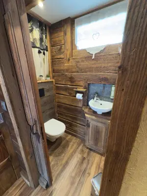 a bathroom with a toilet and a sink at le coup de coeur in Les Houches