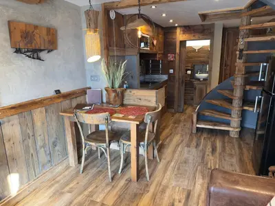 a kitchen and dining room with a table and chairs at le coup de coeur in Les Houches