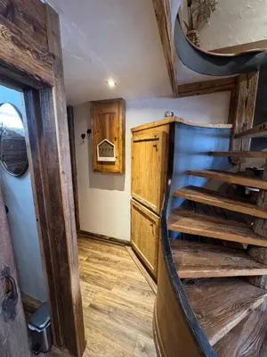 a room with wooden stairs in a tiny house at le coup de coeur in Les Houches