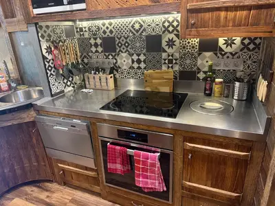 a kitchen with a stove and a sink at le coup de coeur in Les Houches