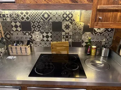 a kitchen counter with a stove top in a kitchen at le coup de coeur in Les Houches