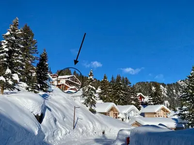 a snow covered mountain with houses and trees at Vue panoramique sur les montagnes plein Sud - T2 Skis aux pieds, Piscine & Spa in Flaine