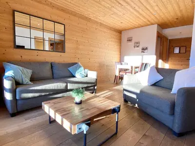 a living room with two couches and a coffee table at Vue panoramique sur les montagnes plein Sud - T2 Skis aux pieds, Piscine & Spa in Flaine
