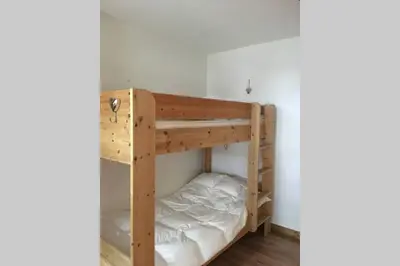 a bunk room with two bunk beds in it at Charmant appartement, centre ville, vue Mont-Blanc in Chamonix-Mont-Blanc