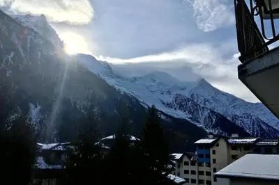 a view of a snow covered mountain with a city at Charmant appartement, centre ville, vue Mont-Blanc in Chamonix-Mont-Blanc