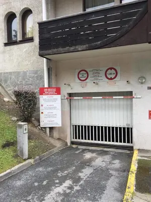 a building with a gate on the side of it at Charmant appartement, centre ville, vue Mont-Blanc in Chamonix-Mont-Blanc