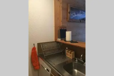 a kitchen with a sink and a counter top at Charmant appartement, centre ville, vue Mont-Blanc in Chamonix-Mont-Blanc