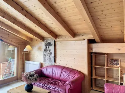 a leather couch in a room with a wooden ceiling at Duplex cosy à deux pas des pistes avec parking à Combloux - FR-1-560-80 in Combloux