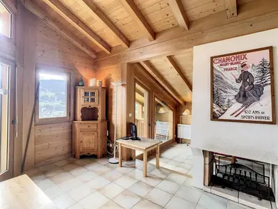 a living room with a fireplace in a wooden house at Duplex cosy à deux pas des pistes avec parking à Combloux - FR-1-560-80 in Combloux