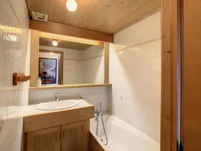 a bathroom with a sink and a tub and a mirror at Duplex cosy à deux pas des pistes avec parking à Combloux - FR-1-560-80 in Combloux