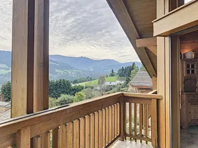 a balcony of a house with a view of mountains at Duplex cosy à deux pas des pistes avec parking à Combloux - FR-1-560-80 in Combloux