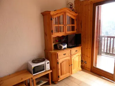 a kitchen with a microwave and a cabinet with a microwave at Résidence Les Loges - Loges 11 MAE-4364 in Saint-Gervais-les-Bains