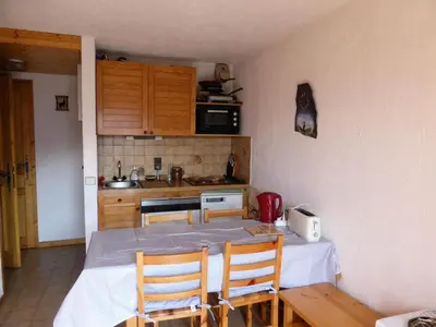 a kitchen with a table and chairs in a room at Résidence Les Loges - Loges 11 MAE-4364 in Saint-Gervais-les-Bains