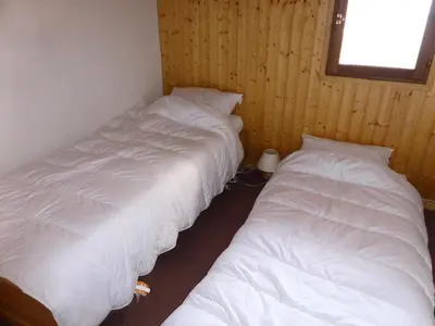 two white beds in a room with a window at Résidence Les Loges - Loges 11 MAE-4364 in Saint-Gervais-les-Bains