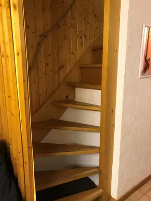 a set of wooden stairs in a room at Résidence Les Loges - Loges 11 MAE-4364 in Saint-Gervais-les-Bains