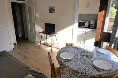 a dining room table with plates on it in a kitchen at Résidence Castel Des Roches C - Castel des Roches A27 MAE-4374 in Saint-Gervais-les-Bains
