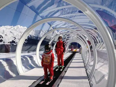 a woman and a child on skis in a tunnel at Samoëns 1600 les cimes in Samoëns
