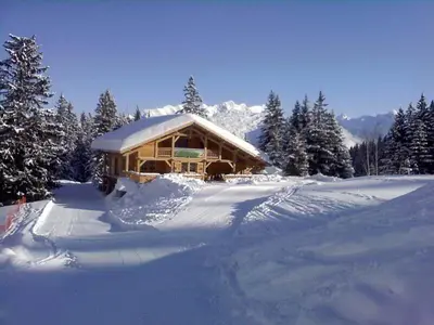 a log cabin with snow on the ground at Samoëns 1600 les cimes in Samoëns