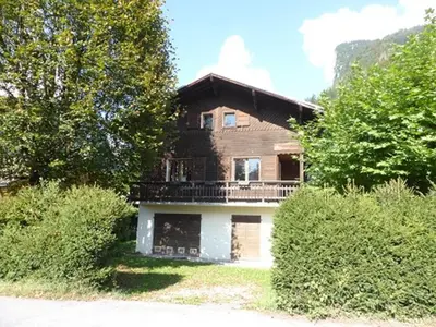 a large wooden house in the middle of trees at Chalet Gentiane - un lieu idéal pour des vacances en famille ou entre amis - FR-1-629-88 in Samoëns