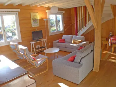 a living room with a couch and a tv at Chalet Gentiane - un lieu idéal pour des vacances en famille ou entre amis - FR-1-629-88 in Samoëns