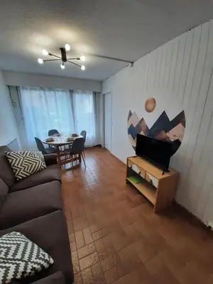 a living room with a couch and a table at Appartement avec terrasse centre samoens in Samoëns
