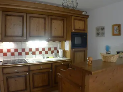 a kitchen with wooden cabinets and a sink at Cosy, 3 pièces au centre, animaux admis, parking - FR-1-629-89 in Samoëns