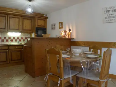 a kitchen with a table and chairs in a kitchen at Cosy, 3 pièces au centre, animaux admis, parking - FR-1-629-89 in Samoëns