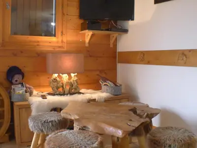 a dining room with a wooden table and chairs at Cosy, 3 pièces au centre, animaux admis, parking - FR-1-629-89 in Samoëns