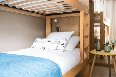 a bunk bed in a room with a bed sidx sidx sidx at Le Beausite C Apartment - Chamonix All Year in Chamonix-Mont-Blanc
