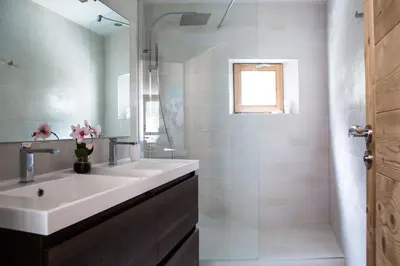 a white bathroom with a sink and a shower at Le Beausite C Apartment - Chamonix All Year in Chamonix-Mont-Blanc