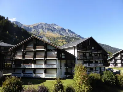 a building with a mountain in the background at Résidence Combettes - Les Combettes D258 MAE-0324 in Les Contamines-Montjoie
