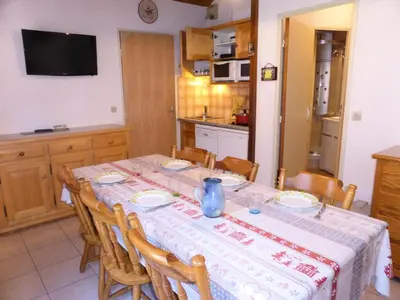 a dining room with a table and a kitchen at Résidence Combettes - Les Combettes D258 MAE-0324 in Les Contamines-Montjoie