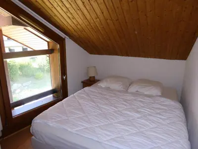 a bedroom with a white bed and a window at Résidence Combettes - Les Combettes D258 MAE-0324 in Les Contamines-Montjoie