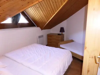 a bedroom with two beds and a wooden ceiling at Résidence Combettes - Les Combettes D258 MAE-0324 in Les Contamines-Montjoie