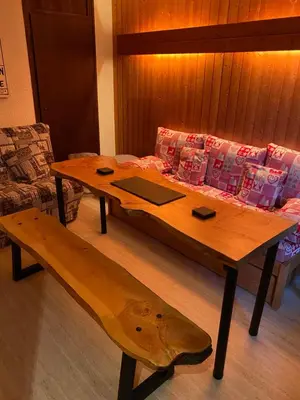 a wooden coffee table with a bench and a couch at Loge des rêveurs in Les Carroz d'Araches