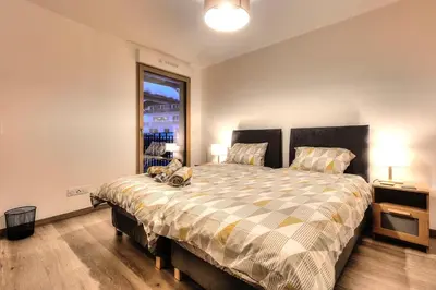 a bedroom with a large bed and a window at Apartment Gallery Mont Blanc Saint-Gervais-Les-Bains in Saint-Gervais-les-Bains