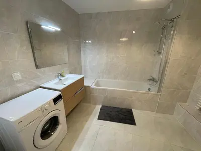 a bathroom with a washing machine and a bath tub at Apartment Gallery Mont Blanc Saint-Gervais-Les-Bains in Saint-Gervais-les-Bains