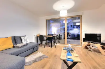 a living room with a couch and a table at Apartment Gallery Mont Blanc Saint-Gervais-Les-Bains in Saint-Gervais-les-Bains