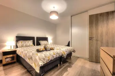 a bedroom with a bed with a teddy bear on it at Apartment Gallery Mont Blanc Saint-Gervais-Les-Bains in Saint-Gervais-les-Bains
