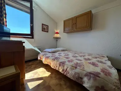 a small bedroom with a bed and a window at Appartement skis aux pieds à Samoëns 1600 - FR-1-624-79 in Samoëns