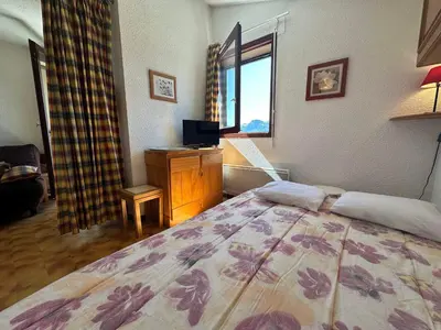 a bedroom with a large bed and a window at Appartement skis aux pieds à Samoëns 1600 - FR-1-624-79 in Samoëns