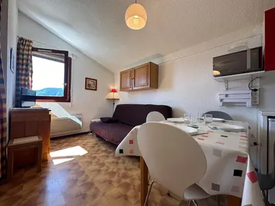 a living room with a table and a couch at Appartement skis aux pieds à Samoëns 1600 - FR-1-624-79 in Samoëns