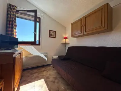 a living room with a couch and a window at Appartement skis aux pieds à Samoëns 1600 - FR-1-624-79 in Samoëns