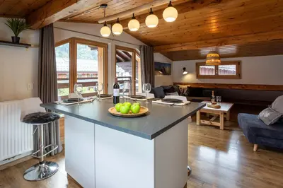 a kitchen with a counter with a bowl of fruit on it at Neige Apartment - Chamonix All Year in Chamonix-Mont-Blanc