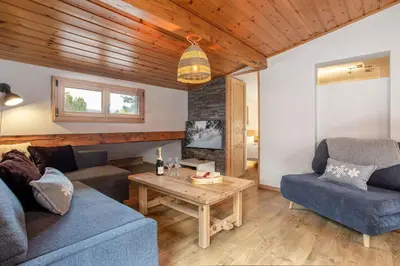 a living room with a couch and a table at Neige Apartment - Chamonix All Year in Chamonix-Mont-Blanc