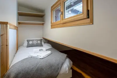 a small room with two beds and a cabinet at Neige Apartment - Chamonix All Year in Chamonix-Mont-Blanc